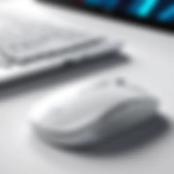 White wireless mouse next to a laptop